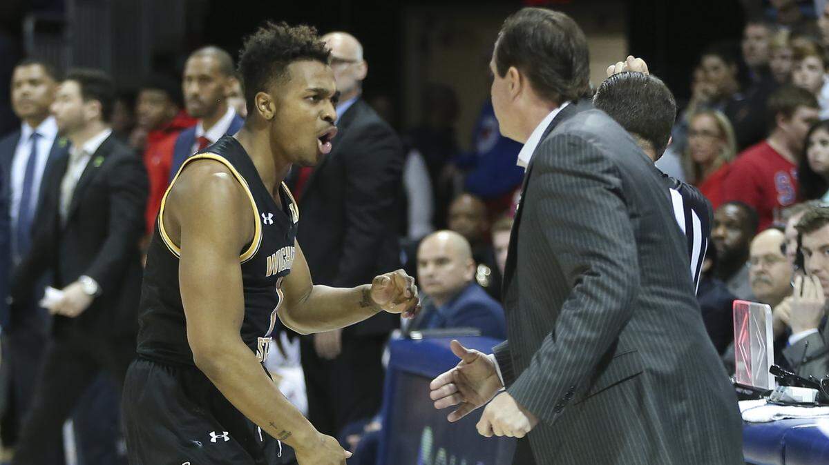 Tyson Etienne celebrates with coach Gregg Marshall while the Shockers chip away at a 24 deficit to SMU in the second half. Wichita State went on to win 66-62 (March 1, 2020).