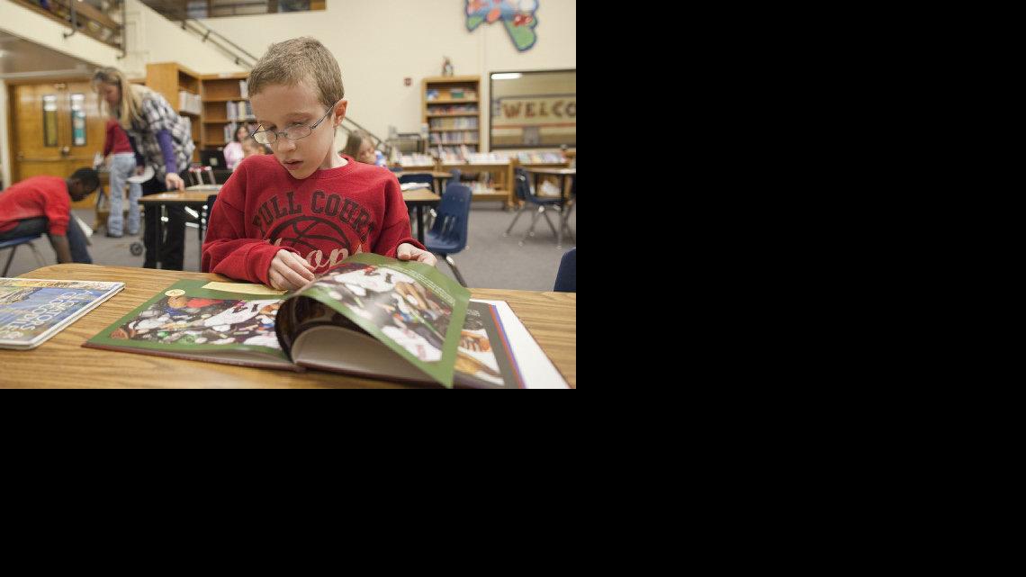 Taylor Parsons reads in the library of John Bryant Elementary. (Feb. 3, 2012)