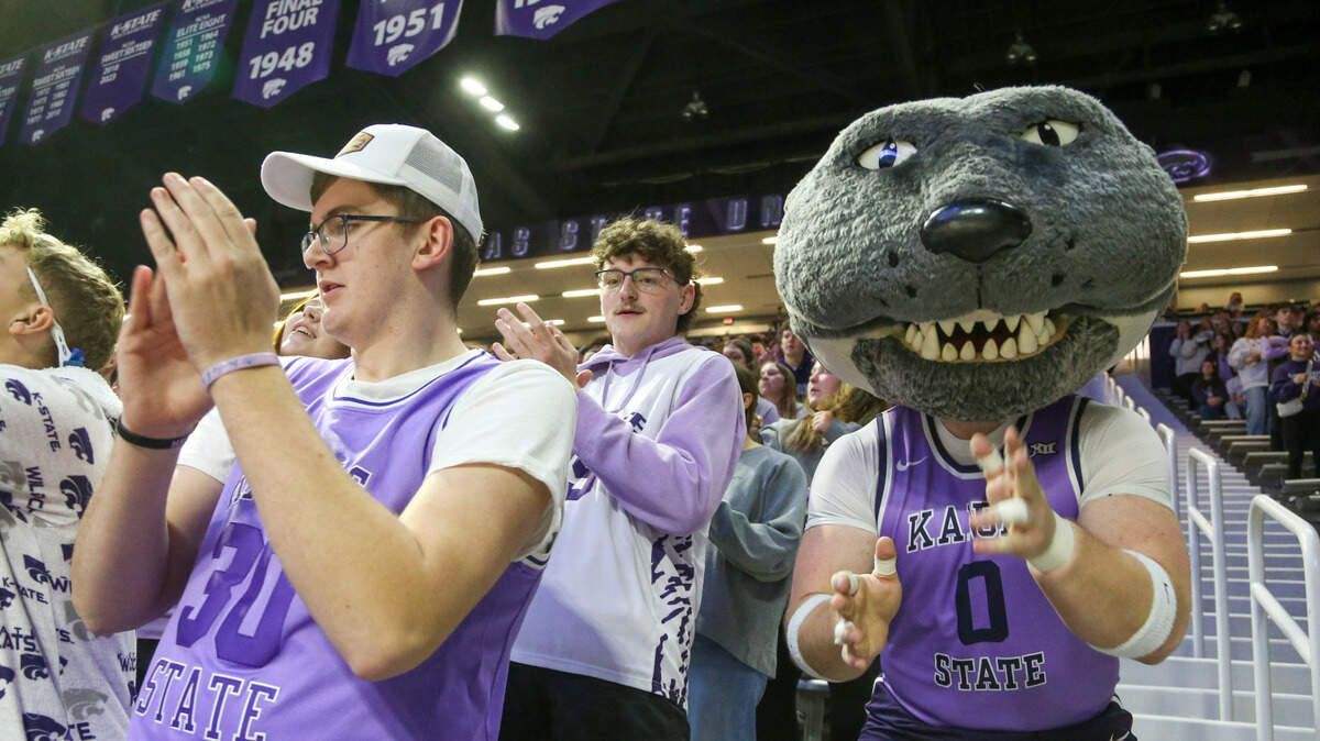 Kansas State Wildcats mascot Willie Wildcats celebrates with fans before the start of a game against the West Virginia Mountaineers at Bramlage Coliseum.