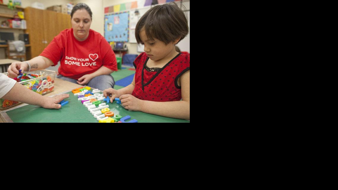 Lilly Gonzalez, right, and para-educator Laurie Briley work on a lesson at John Bryant Elementary. (Feb. 3, 2012)