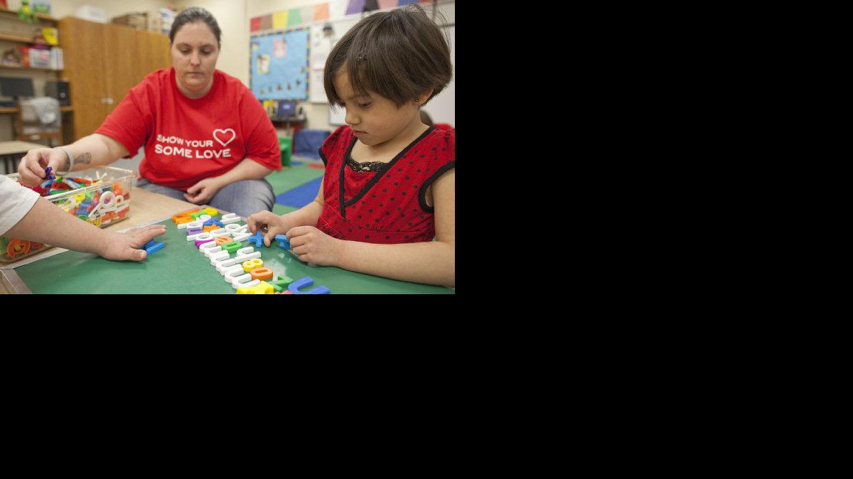 Lilly Gonzalez, right, and para-educator Laurie Briley work on a lesson at John Bryant Elementary. (Feb. 3, 2012)