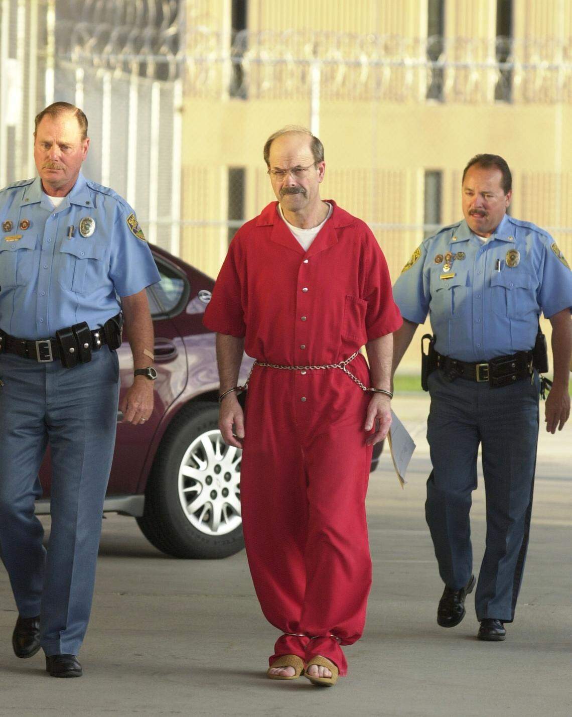Convicted serial killer Dennis Rader, known as the BTK strangler walks into the El Dorado Correctional Facility with two Sedgwick County sheriff’s deputies on Friday, August 19, 2005, in El Dorado, Kansas. Rader was convicted of killing 10 people in a 30-year span and sentenced to 10 consecutive life terms.