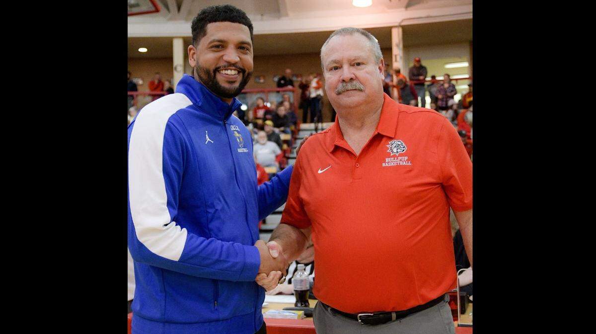 Circle coach Jordan Crawford (left) shakes hands with McPherson coach Kurt Kinnamon, whom he played for as a star player in McPherson in 2007.