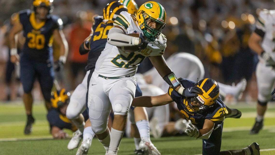 Senior running back Jadonn Williams powers his way for a touchdown in Bishop Carroll’s 37-27 win over Northwest on Thursday.