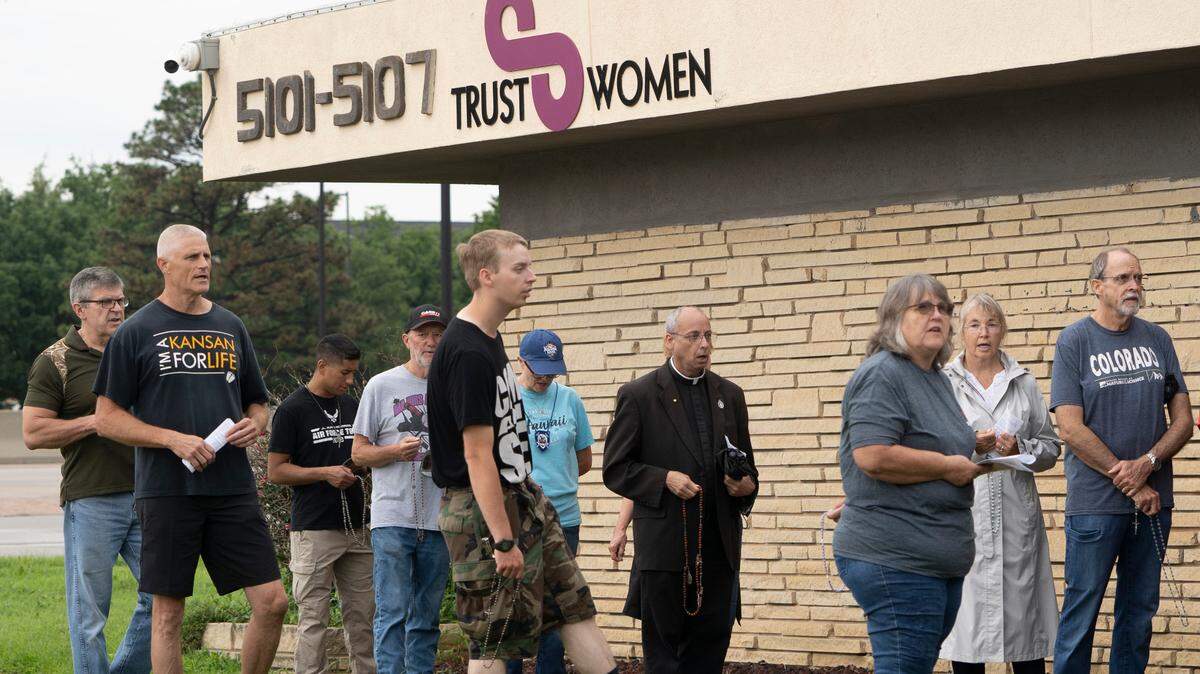 The Rev. Edmond Kline, A Catholic pries, prays the rosary with a group of 45 people gathered in front of Trust Women, an abortion provider.
