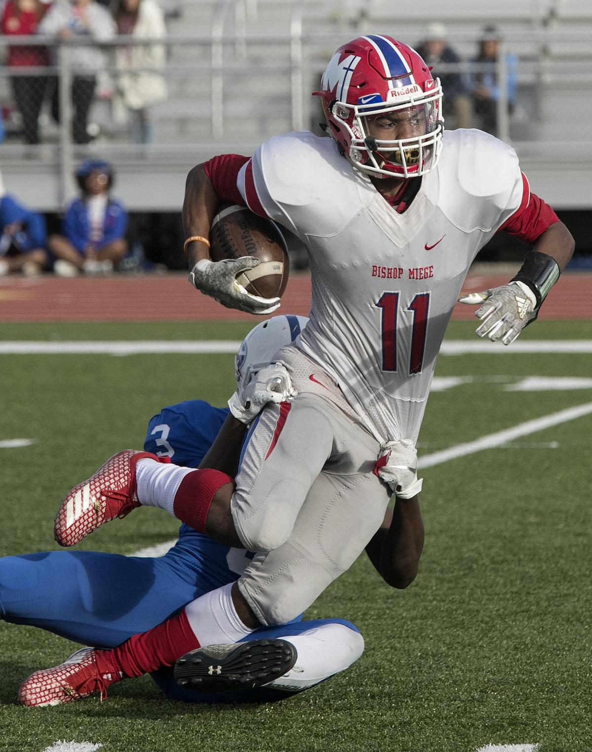 Phillippe Wesley #11, of Bishop Miege was tackled by Nalell Kapten #3 of Goddard in the Kansas Class 4a championship Saturday, November 24, 2018 at Topeka Hummer complex. Bishop Miege won the championship.