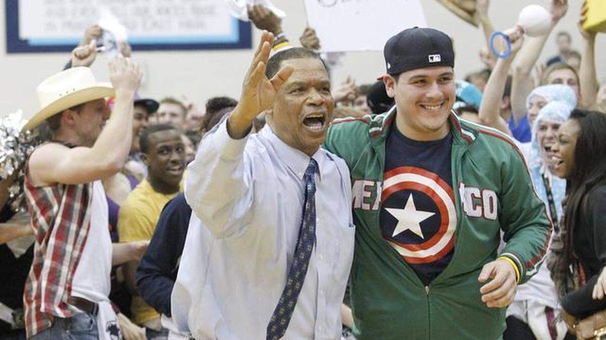 East coach Ron Allen gets mobbed by East students after upsetting Heights 57-51 in February 2012.