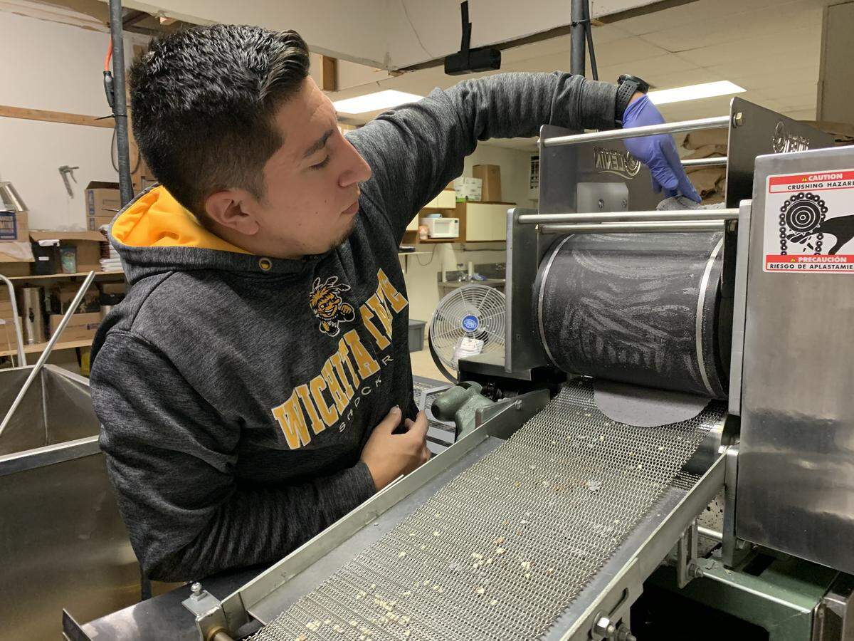 Eddie Sandoval, owner of Pinole Blue, demonstrates his new tortilla making machine that will allow him to start selling freshly made blue corn tortillas.