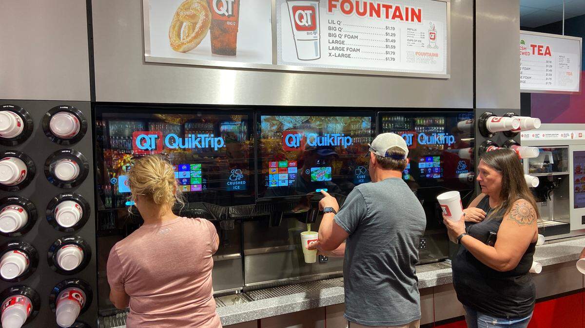 QuikTrip patrons check out the new beverage dispensers at the 29th and Maize Road store in June 2025.