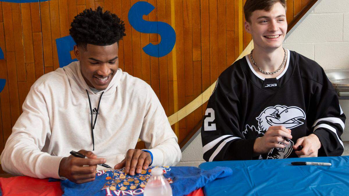 University of Kansas basketball stars Ochai Agbaji, left, and Christian Braun sign autographs at East High School. Wichita was the first stop of the state-wide barnstorming tour for the Kansas men’s basketball national championship team. Because of recent NCAA policy changes, all 18 players on the 2021-22 KU team - not just the graduating seniors - were eligible to participate on the tour. (April 23, 2022)
