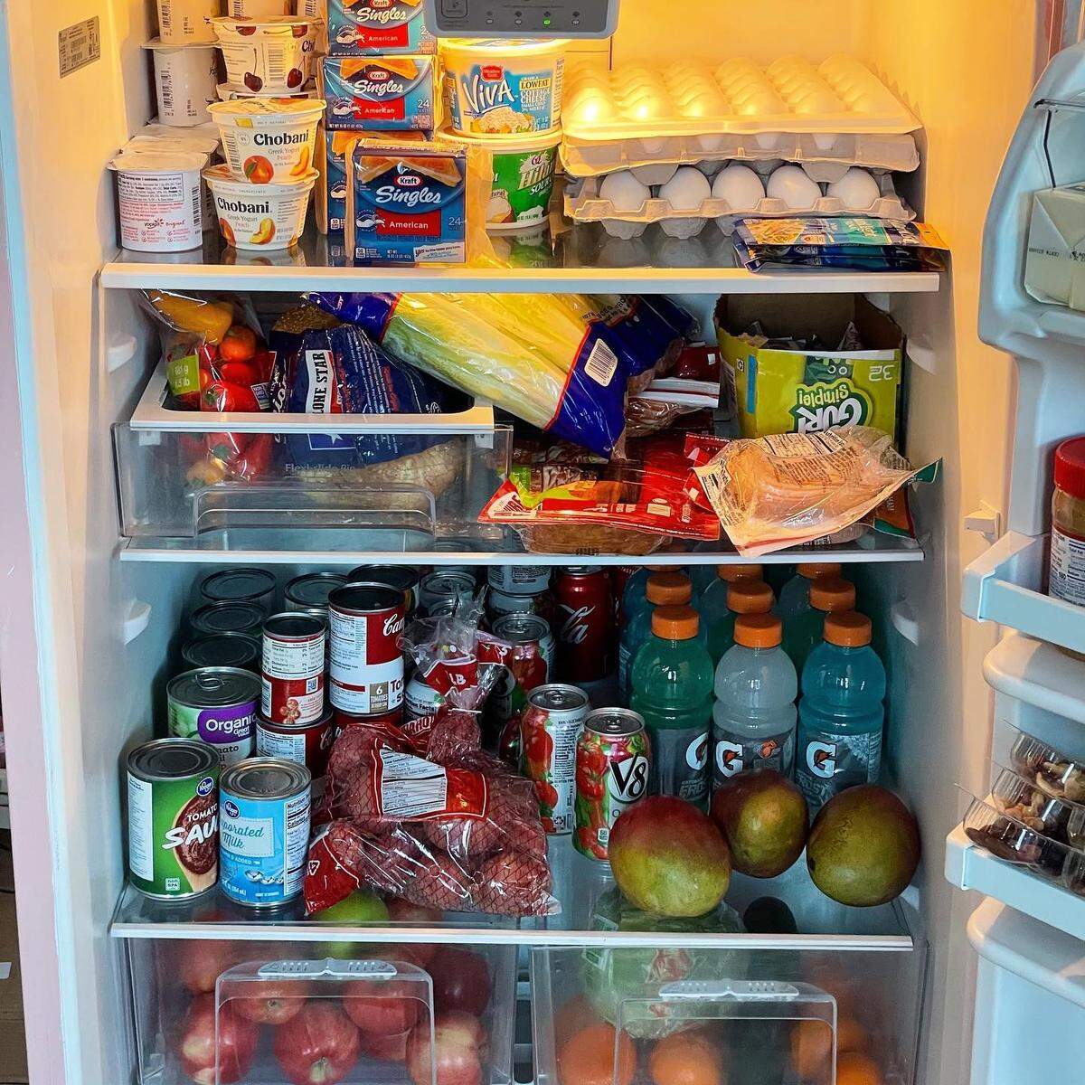 Donors stock the pink refrigerator in Leslie Coffee Co.’s dining room with pre-packaged items people can take if they need them.