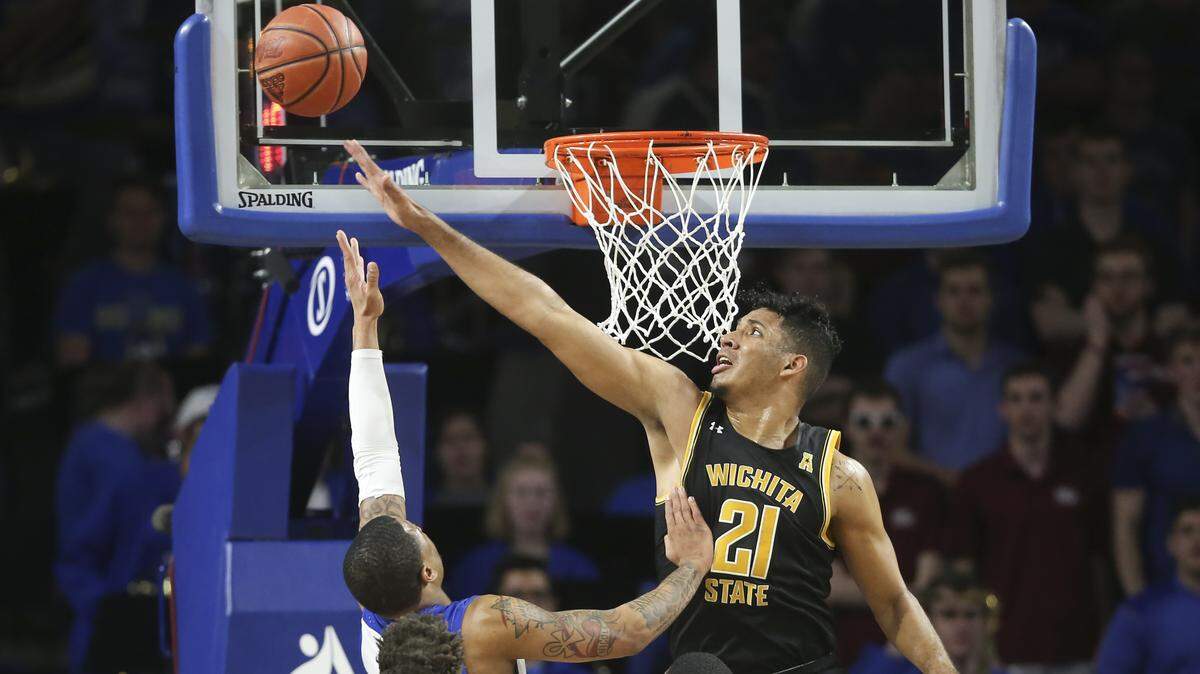 Wichita State’s Jaime Echenique tries to block the shot of Tulsa’s Elijah Joiner during the first half at Tulsa on Saturday.