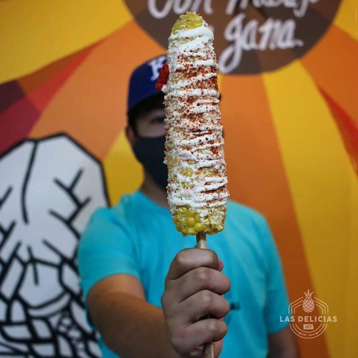 Elote on a stick is one of the specialties at Las Delicias ICT.