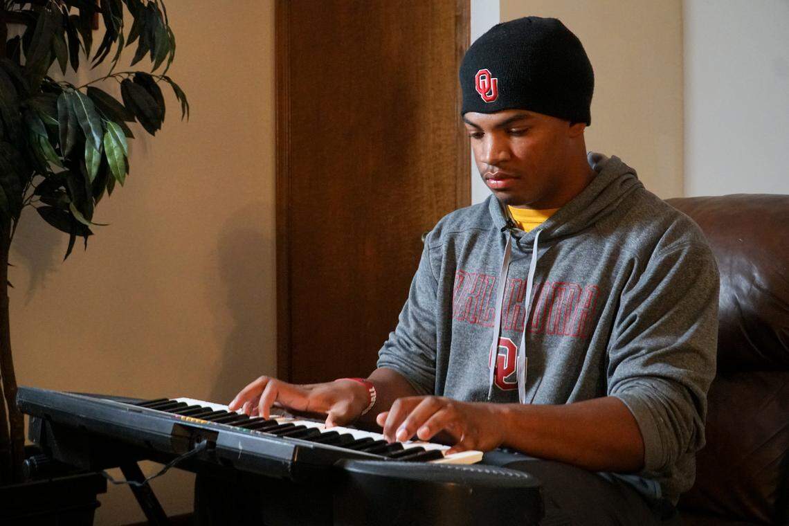 Wichita Northwest senior Marcus Hicks plays the keyboard in his living room. Hicks has verbally committed to Oklahoma. He enjoys music and art. (November 21, 2018)