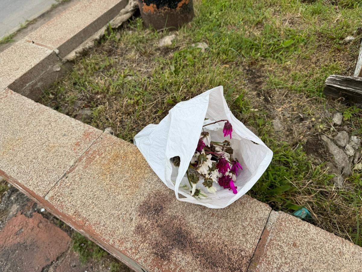 Flowers have been placed at the base of Ming’s iconic neon sign.
