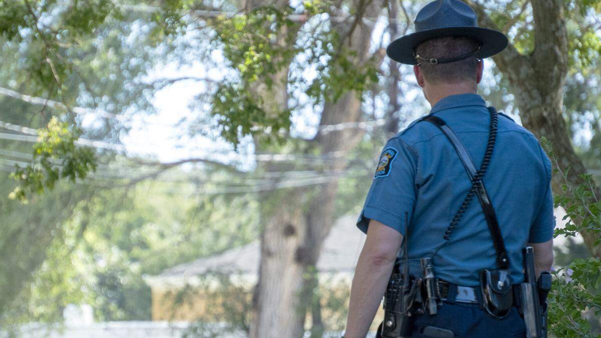 A Kansas Highway Patrol officer on Aug. 16, 2023, stands outside the Marion County Courthouse in Marion, Kansas.