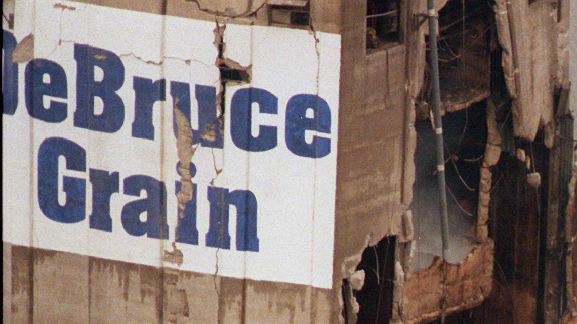 Smoke and dust rise from the remains of the DeBruce Grain elevator south of Wichita in June 1998. A powerful explosion ripped through the elevator killing at least one and injuring many more.