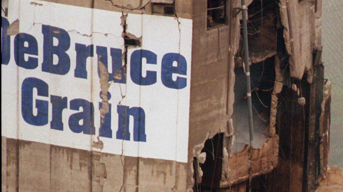 Smoke and dust rise from the remains of the DeBruce Grain elevator south of Wichita in June 1998. A powerful explosion ripped through the elevator killing at least one and injuring many more.