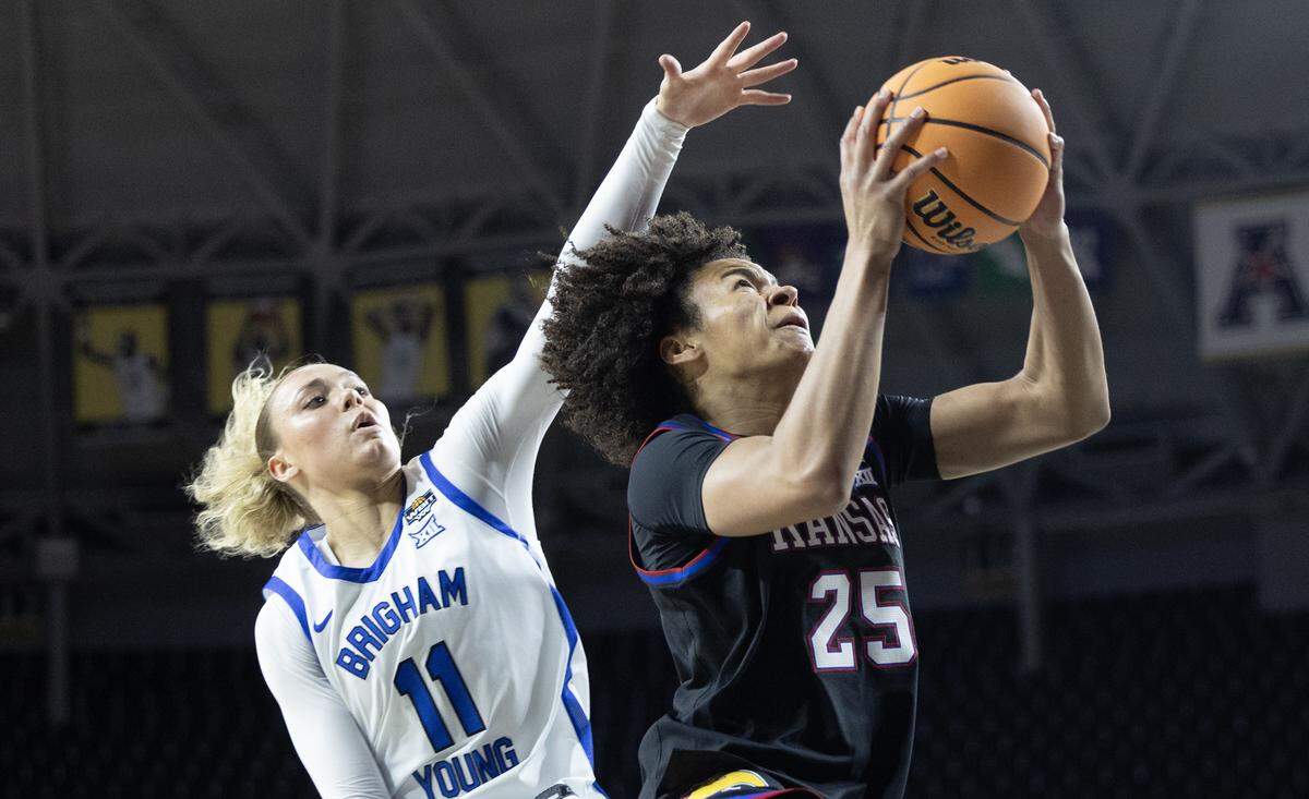 Kansas’ Jaliya David goes to the basket against BYU’s Delaney Gibb during the first half of their WBIT semifinal game at Wichita’s Koch Arena on Monday.