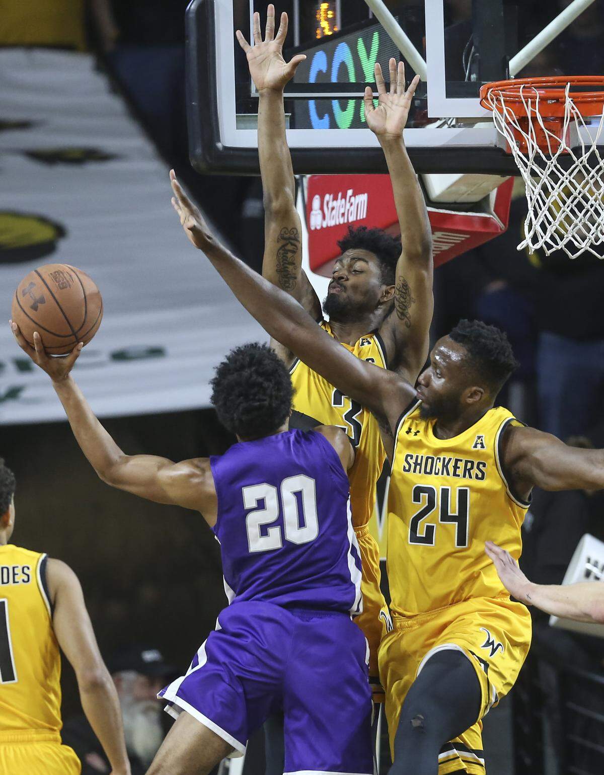 Wichita State’s DeAntoni Gordon and Morris Udeze defend Abilene Christian’s Coryon Mason during the second half of their game at Koch Arena on Sunday.