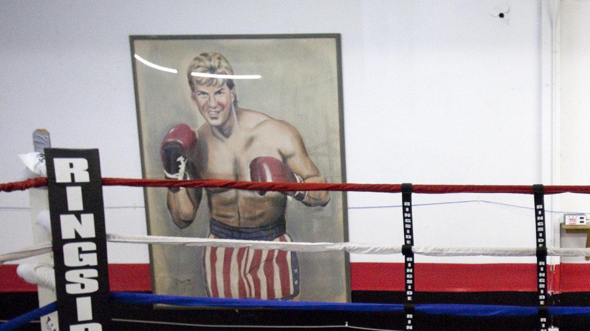 Former heavyweight boxing champion Tommy Morrison shadow boxes in a gym in south Wichita in 2011. Behind Morrison is a drawing of him from 1990.