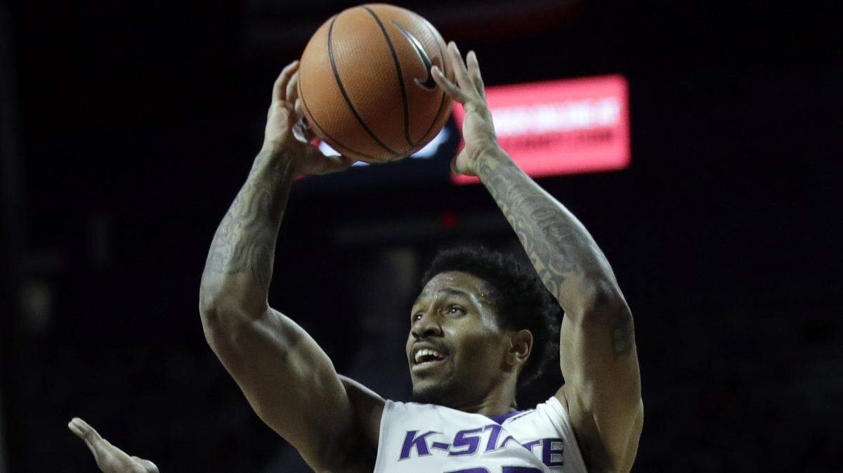 Kansas State guard Amaad Wainright (23) is fouled by Oklahoma State guard Brandon Averette (0) during the second half of an NCAA college basketball game in Manhattan, Kan., Wednesday, Jan. 10, 2018.