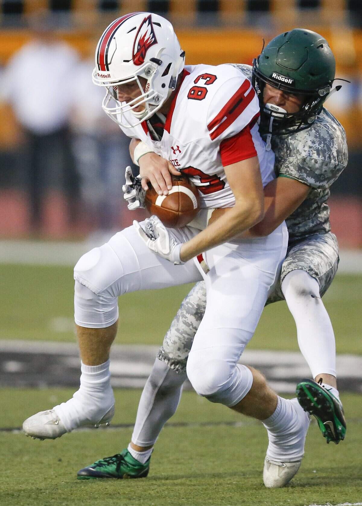 Maize’s Deriq Doty (83) makes a reception against Derby’s Cade Lindsey, right,  during the second quarter at Derby High Friday. (Sept. 15, 2017)