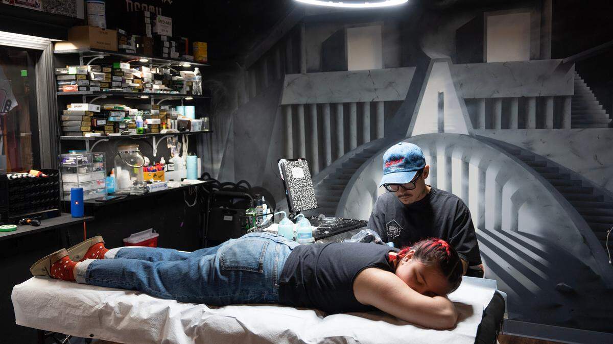 Tattoo artist Thanh Do works on his client, Allison Song, at Afterlife Tattooz in Old Town.