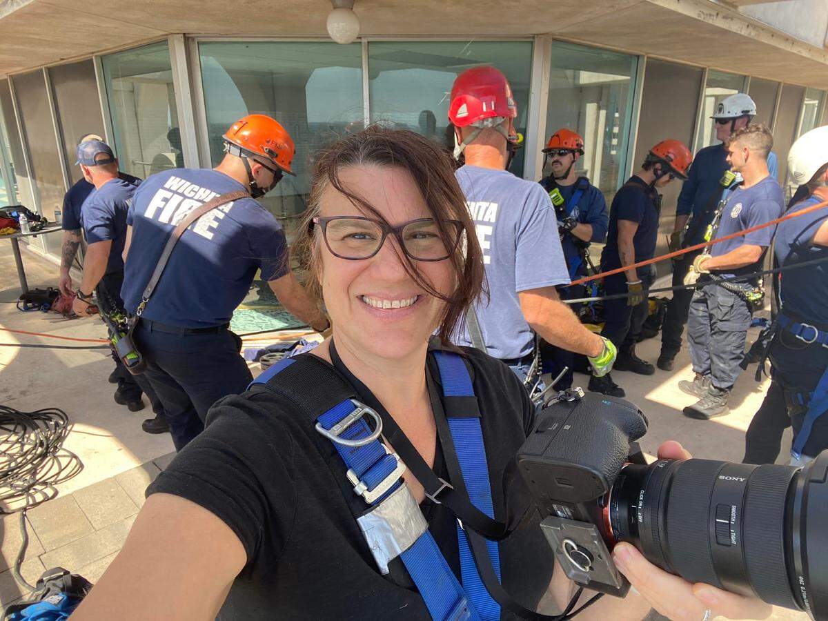 Wichita Eagle visuals editor Jaime Green takes a selfie on assignment shooting the Wichita Fire Department training while rappelling off of the Garvey Center. While Green is known for her photos and videos, some know her for her ever-present, distinctive laugh.