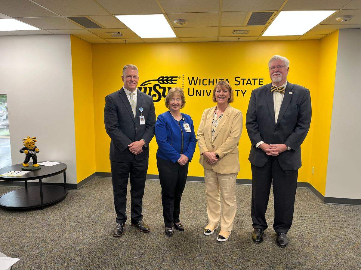 Kevin Strecker, Laurie Labarca, Dr. Shirley Lefever and Dr. Greg Hand finalize the affiliation between Ascension Via Christi and WSU.