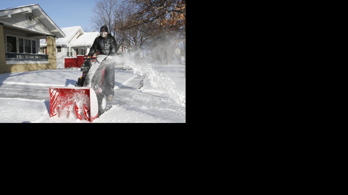 
Matt Brown uses a snow blower to clear snow from his house in Riverside. (Jan. 5, 2014)
