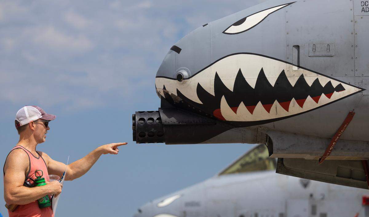 An attendee of the Frontiers in Flight airshow gets an up close look at the gun of an A-10 on Saturday at McConnell Air Force Base.
