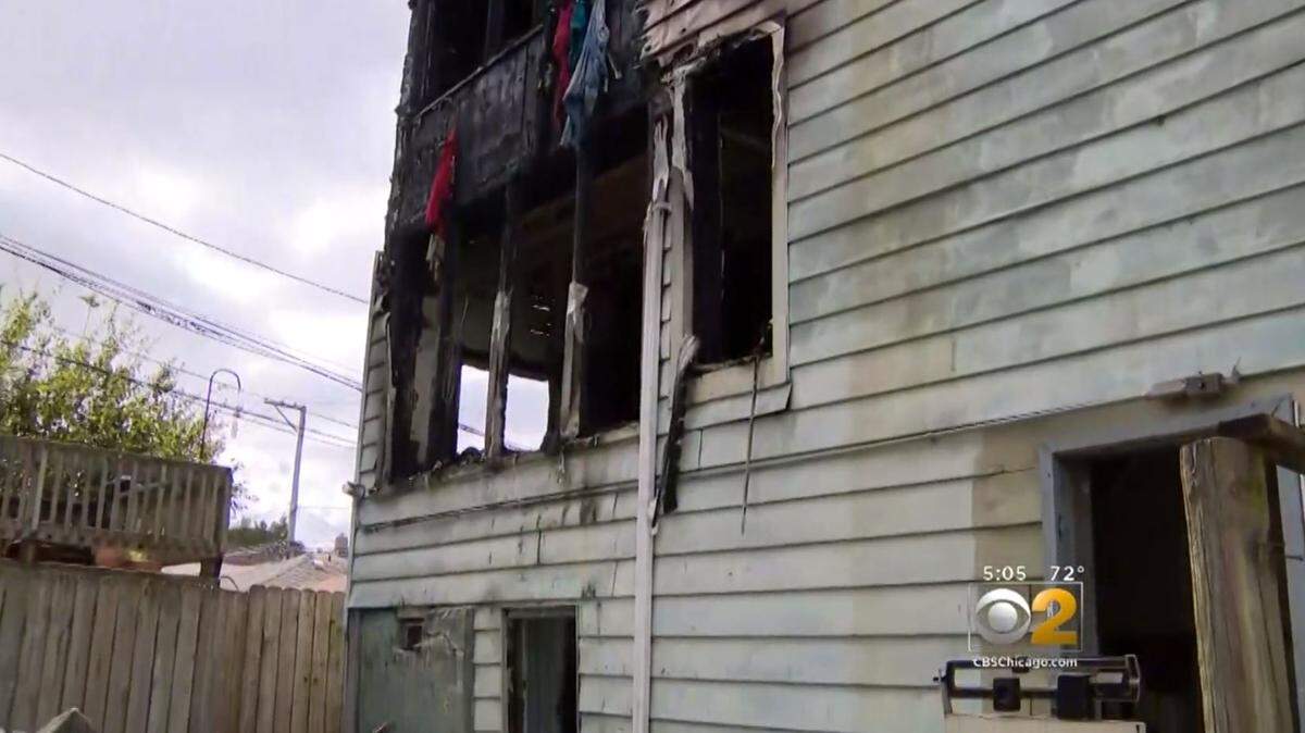 The Chicago Fire Department said a 69-year-old grandfather tossed his 7-year-old grandson from a second floor window into the arms of police officers to save him from a burning home.