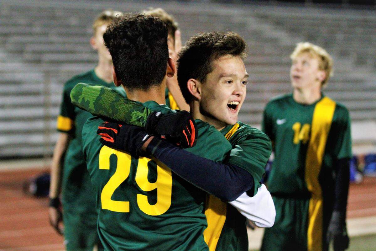 Bishop Carroll junior midfielder Tyler Griffin hugs freshman forward Sebastian Vizcarra after Griffin scores the double overtime, game-winner in the Golden Eagles’ 2-1 state quarterfinal win over Kapaun on Tuesday. (Oct. 30, 2018)