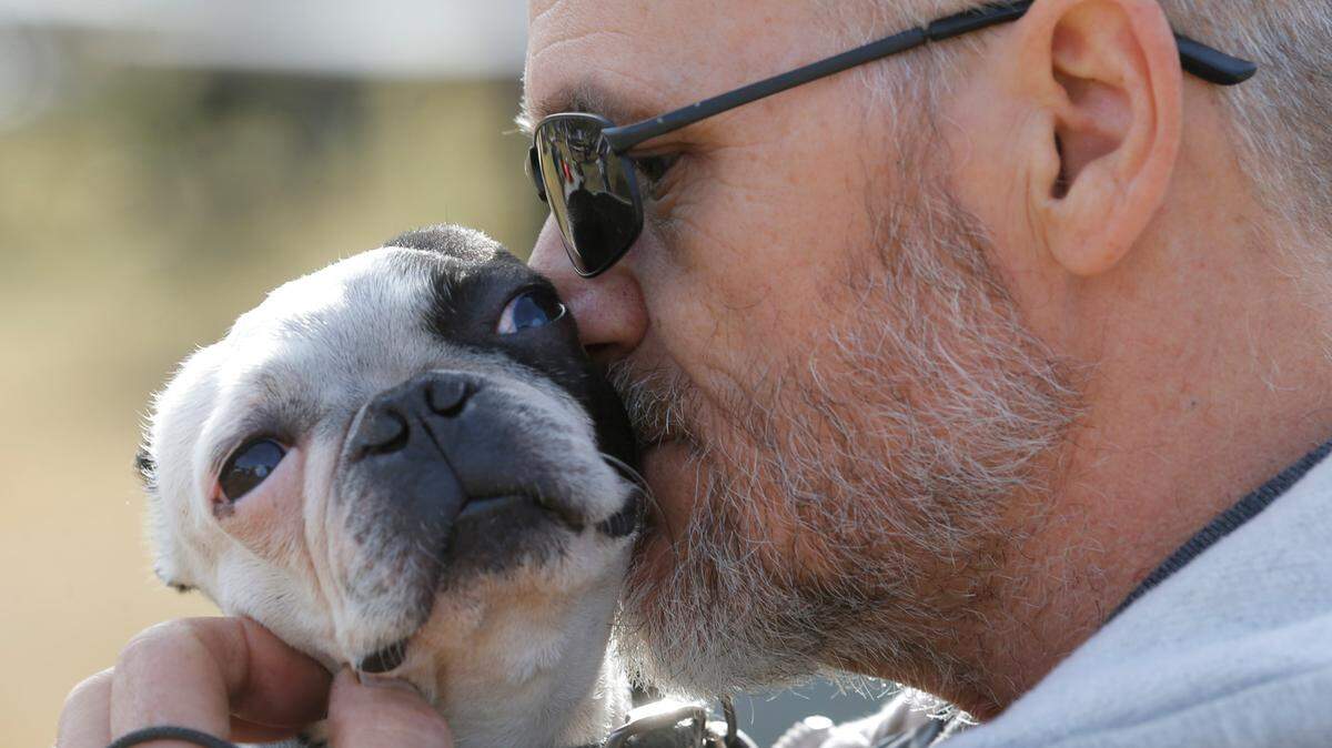 Dave Gilbert snuggles with his dog Brutis at Woofstock, the annual fundraiser for the Humane Society, at Sedgwick County Park in this 2014 photo. Wichita was recently named the No. 4 best U.S. city for pet ownership.