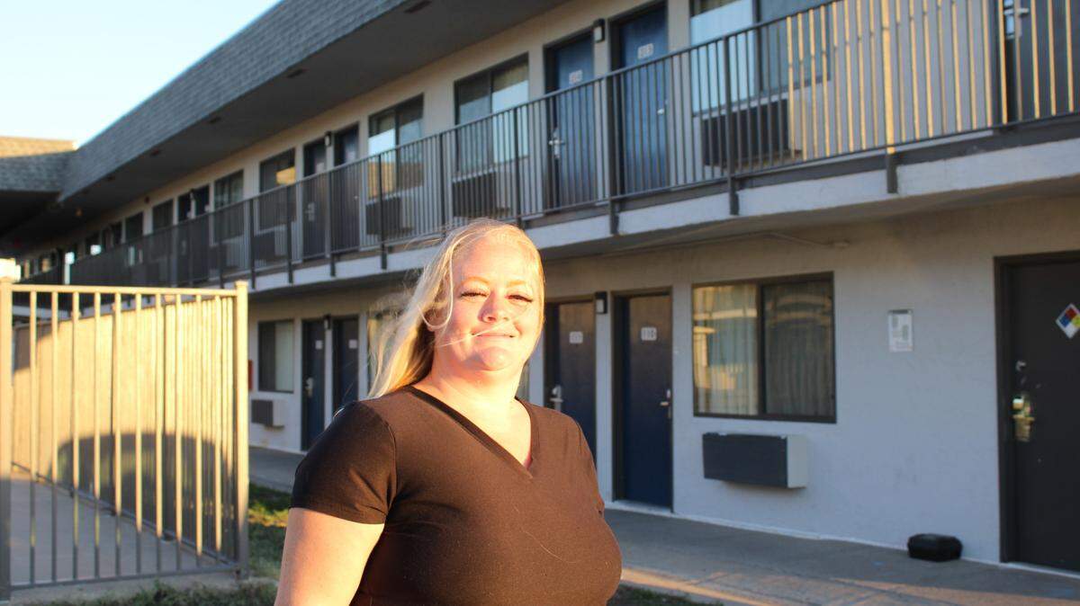 Amy Frey outside the Motel 6 her family stayed at for more than a month, while searching for an apartment and waiting for their lease to start.
