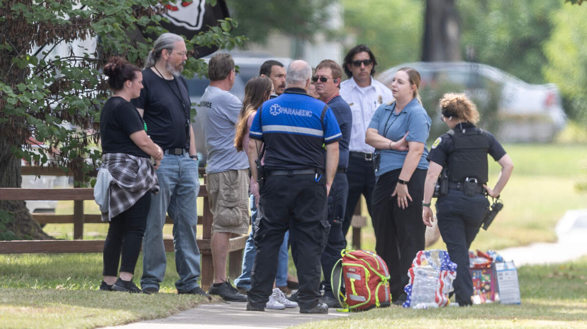 Emergency first responders wait near the scene of what police called an active alert Wednesday afternoon on West 9th Street.