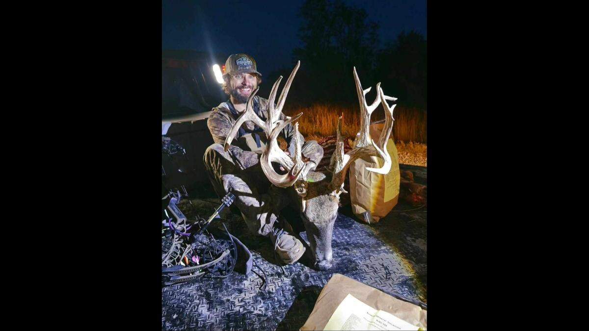 Dallas Birk beams as he holds his massive Kansas whitetail buck.