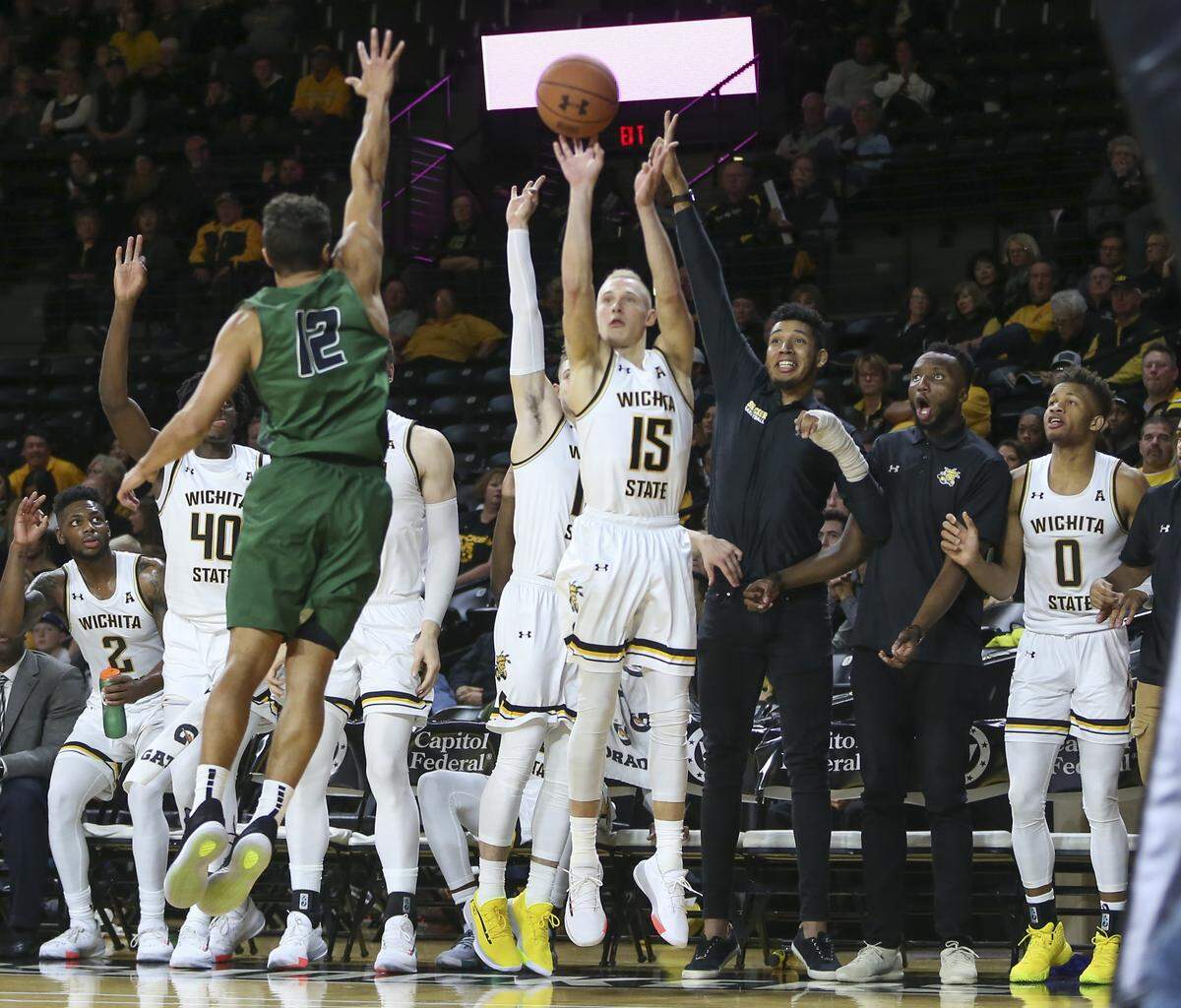 Wichita State players watch in anticipation as teammate Brycen Bush shoots a three pointer late in the game against Northeastern State.