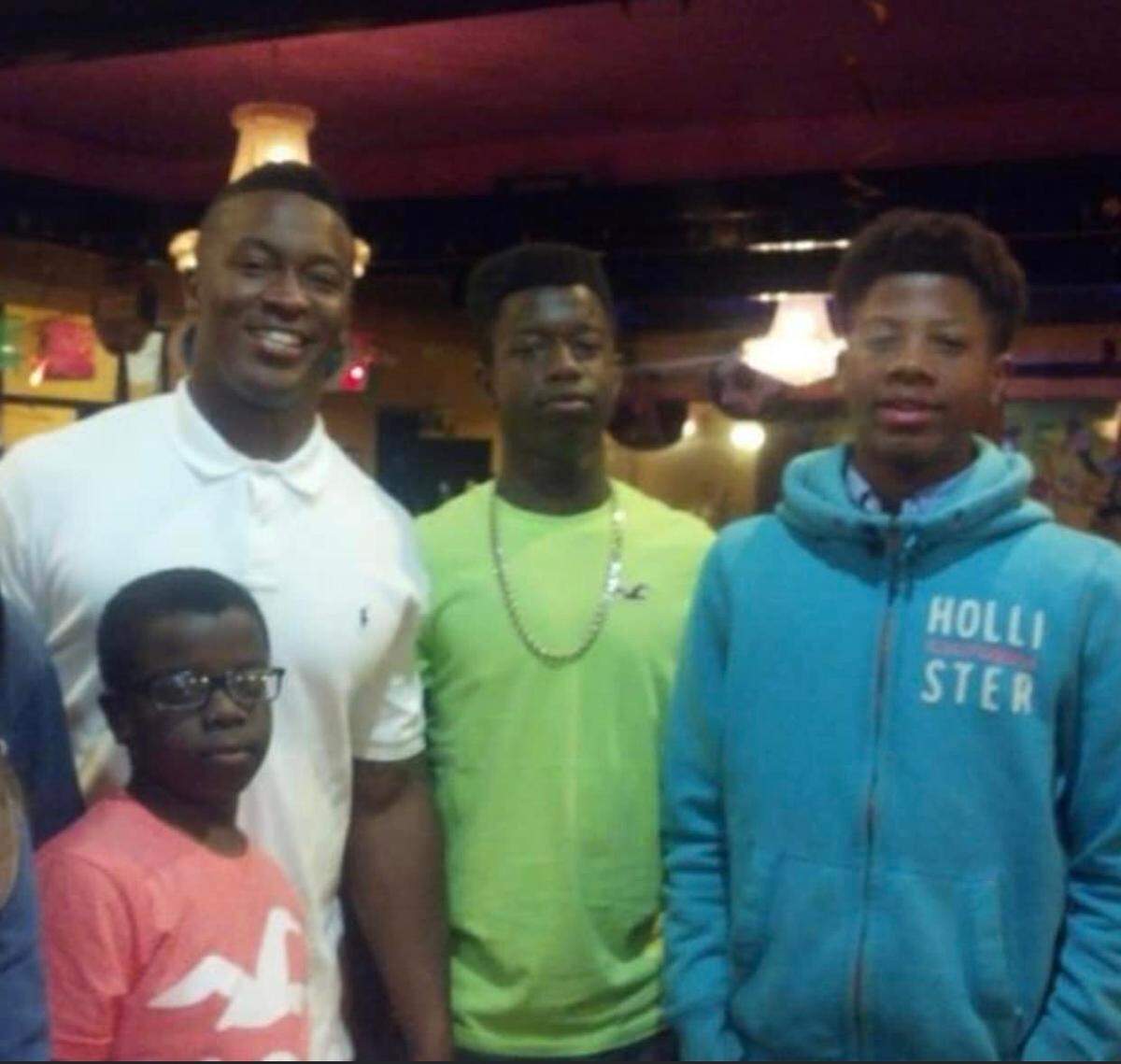 Wichita State basketball player Monzy Jackson, pictured right, grew up idolizing his cousin Demaryius Thomas (back left), who became a star wide receiver in the NFL.