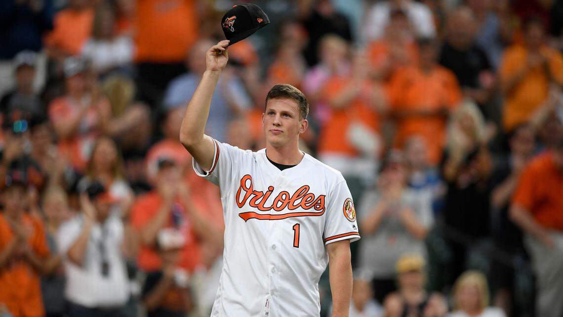 Baltimore Orioles first-round draft pick Adley Rutschman tips his cap to the crowd as he was introduced between innings of a baseball game against the San Diego Padres, Tuesday, June 25, 2019, in Baltimore. (AP Photo/Nick Wass)