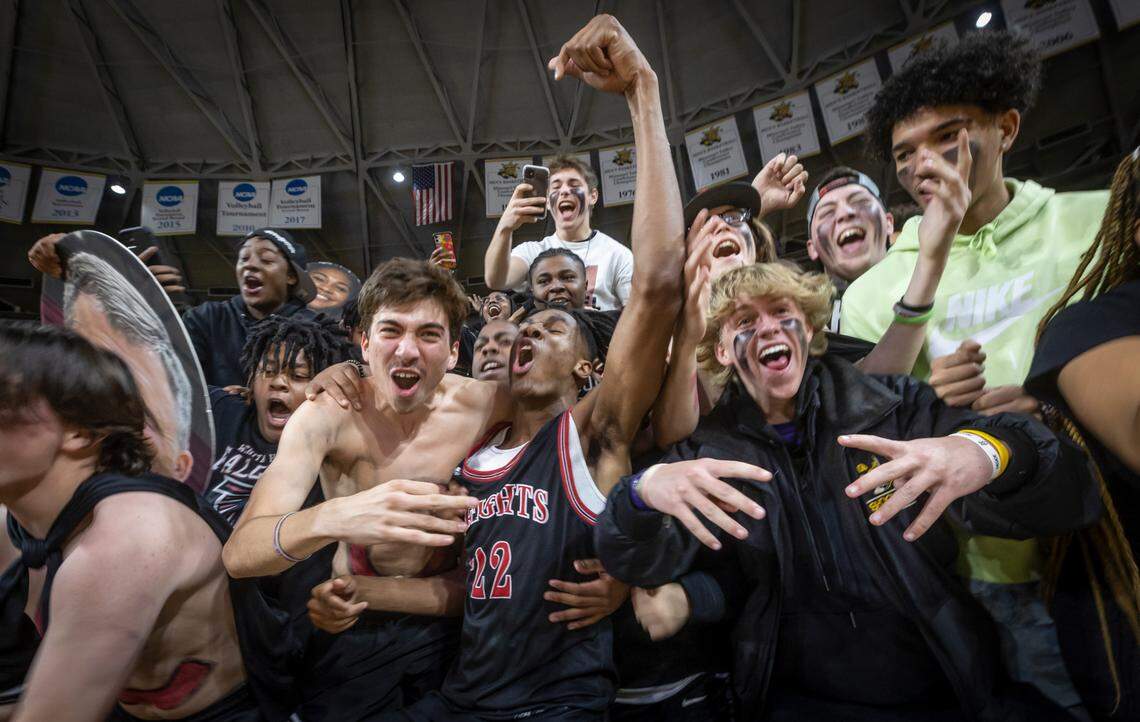 Heights’ Dreylin Kemp celebrates with fans after the Falcons clinched the 6A state title with a win over Blue Valley Northwest at Koch Arena on Saturday.