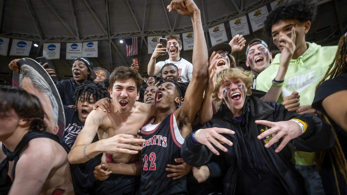 Heights’ Dreylin Kemp celebrates with fans after the Falcons clinched the 6A state title with a win over Blue Valley Northwest at Koch Arena on Saturday.