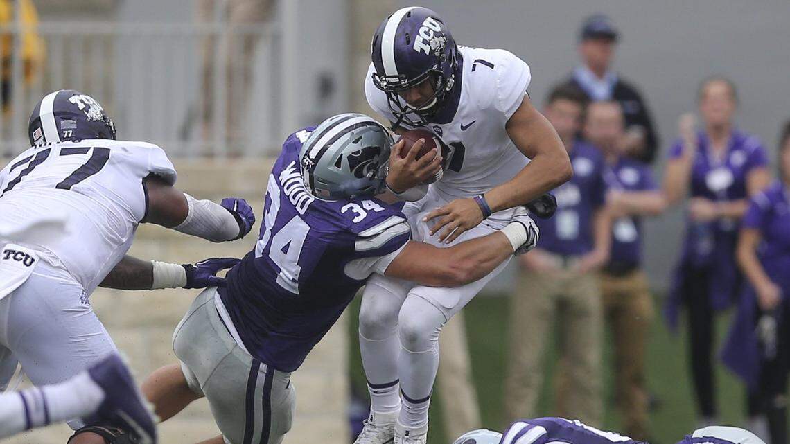 TCU Horned Frogs quarterback Kenny Hill is sacked by Kansas State Wildcats defensive end Tanner Wood during the first half on Saturday in Manhattan. 