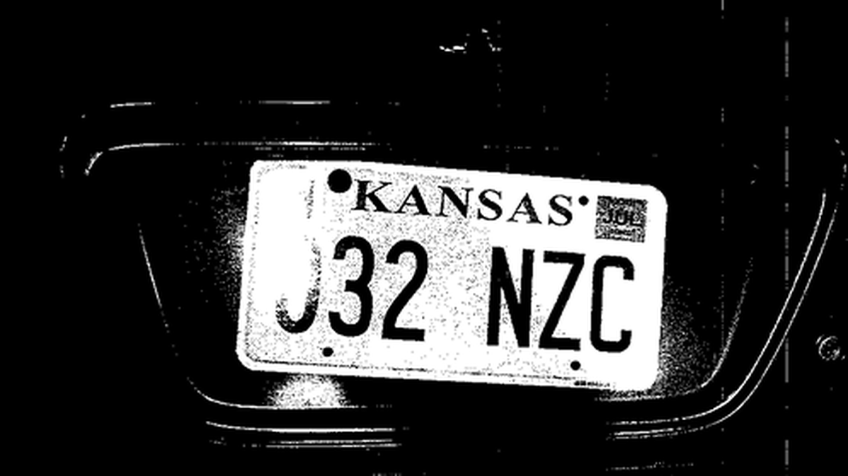 This photograph of the tag, which is held by one bolt and leaning to the right, was admitted into evidence.
