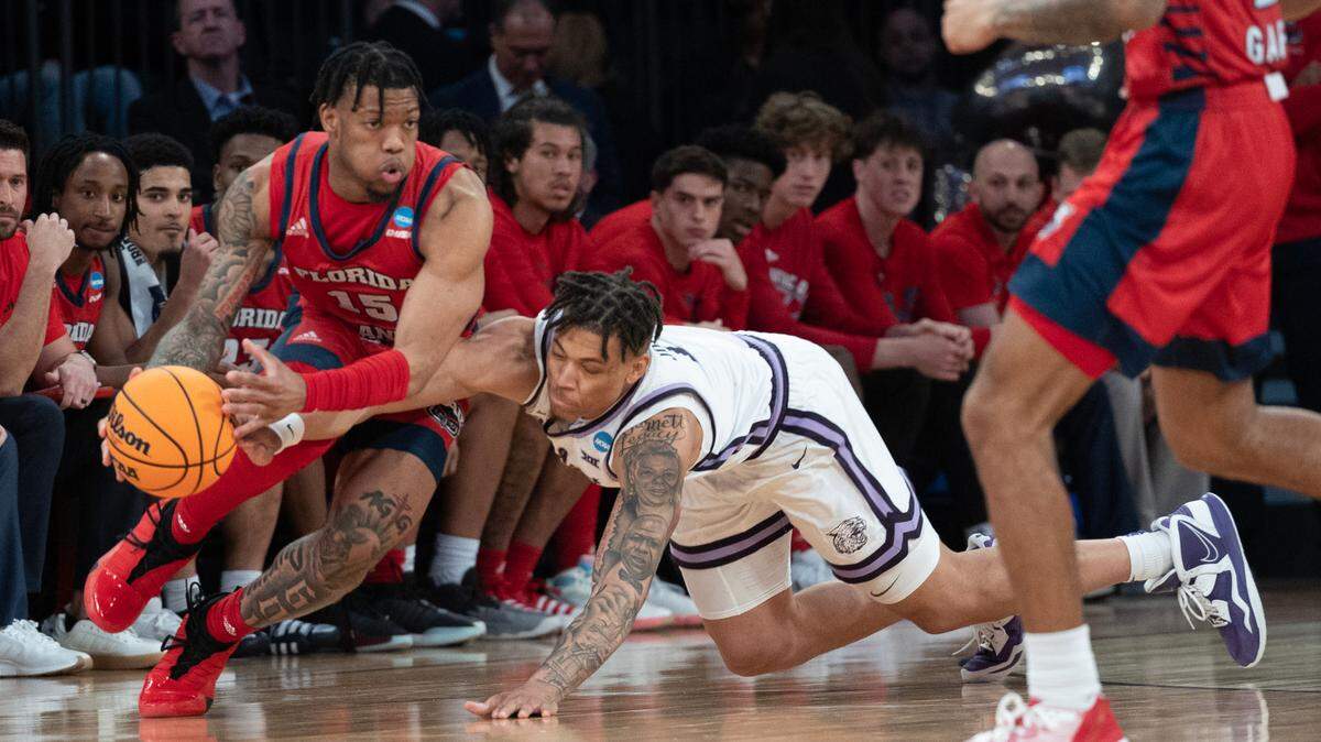 Kansas State’s Keyontae Johnson (on floor) was called for a foul while trying to come up with a loose ball against Florida Atlantic’s Alijah Martin during the second half of their East Region final game at Madison Square Garden on Saturday night, March 25, 2023.