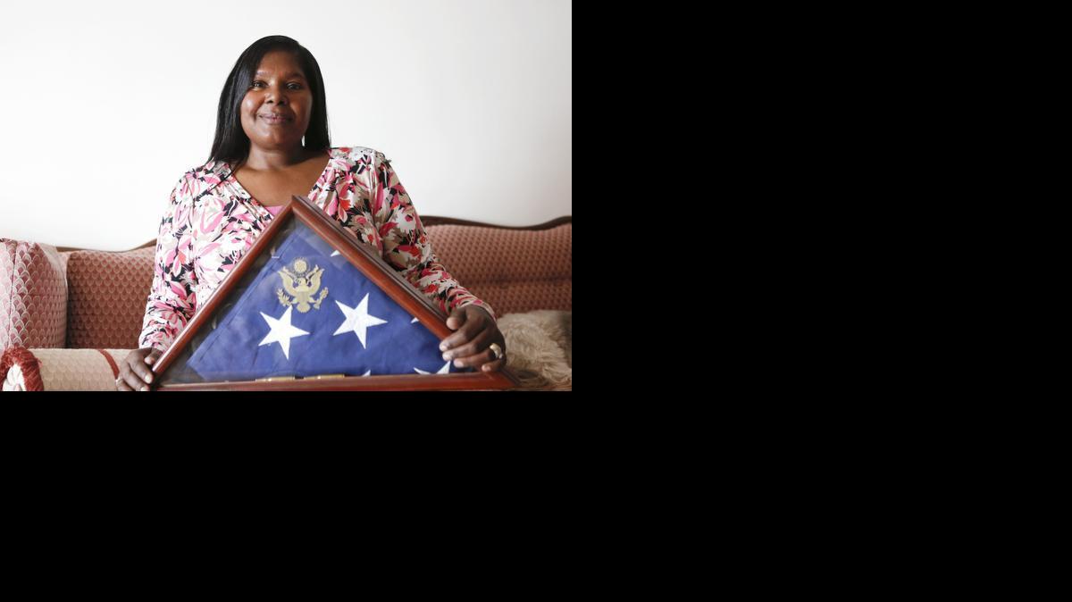 Avis Crosby holds the flag given to her by the Navy after her son Adrian Crosby’s death. Adrian and his cousin Dominique Green were killed by a drunken driver in 2006. 

