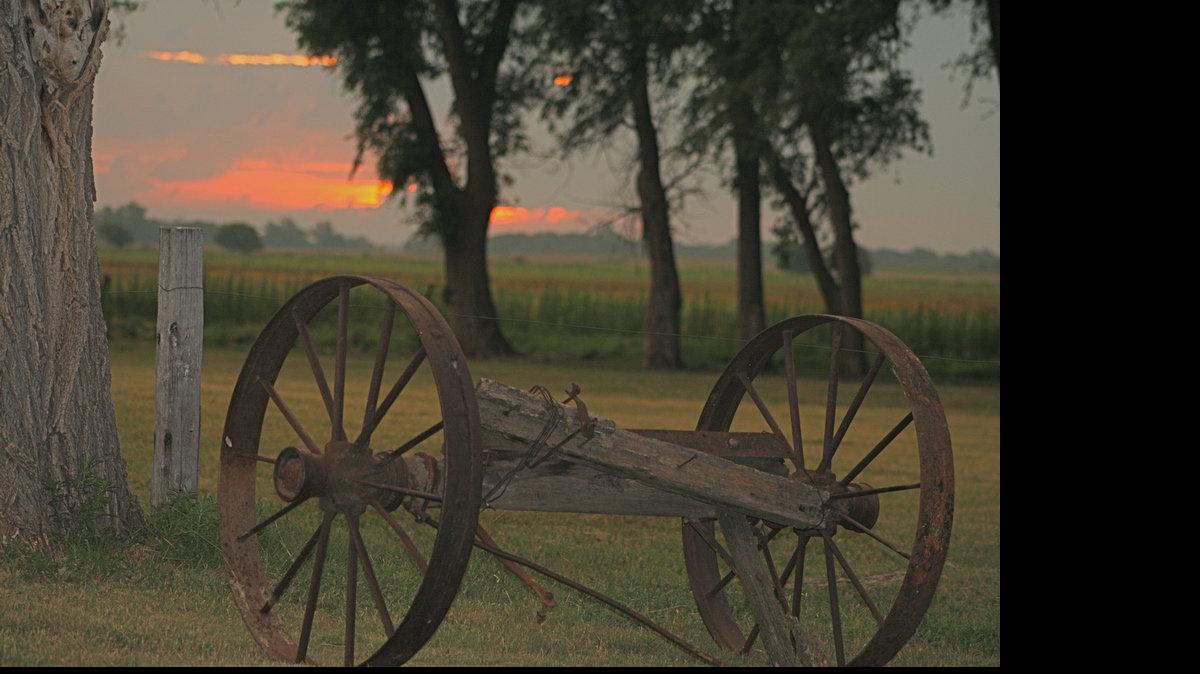 Sunrise on the Foster Farm on Ash Creek near Pawnee Rock, one of the
stopping points along the Santa Fe Trail. Members of the Foster family
placed remnants of an old wagon near their farmstead to commemorate the
historic trail.