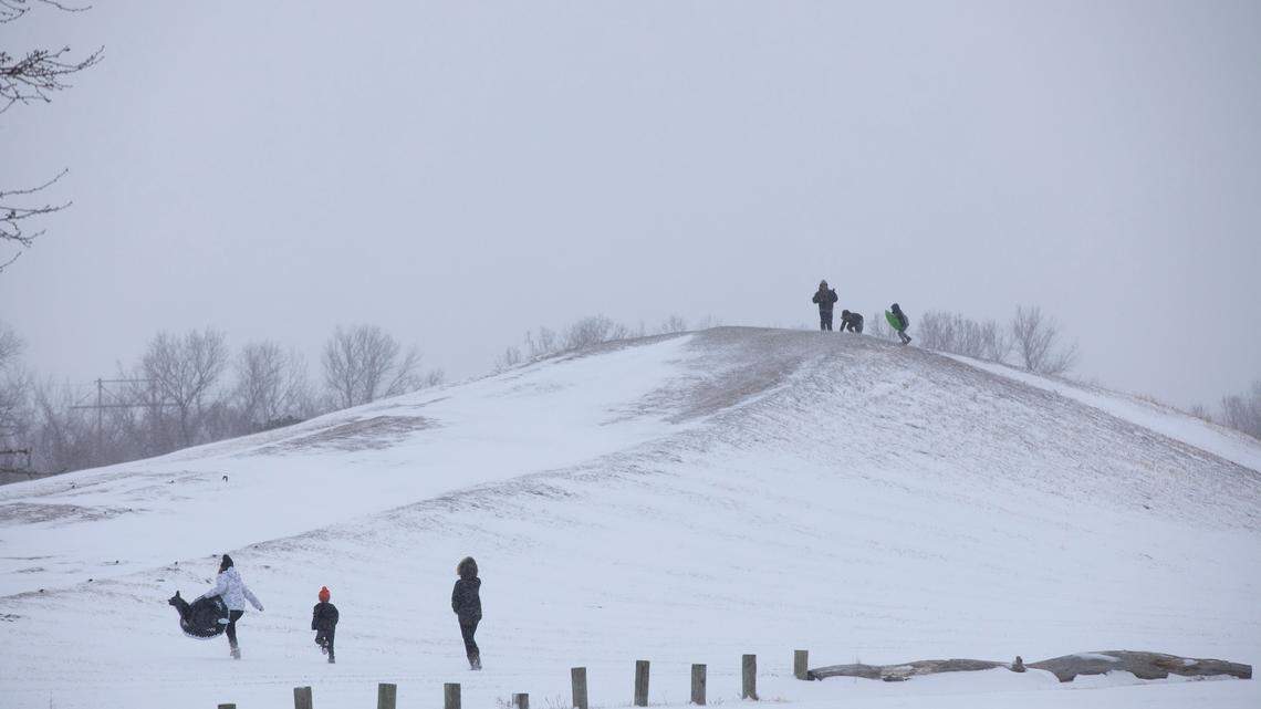 A few folks braved the wind and cold to sled down the hill at Sedgwick County Park. (February 2, 2022)