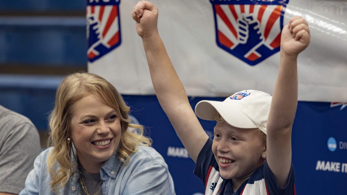 Ryker Ammons, 10, celebrates after signing his letter of intent to become an honorary member of the Newman Jets’ basketball team on Thursday. The signing event was organized by Team IMPACT, a national nonprofit that connects children facing serious or chronic illnesses with college athletic teams.